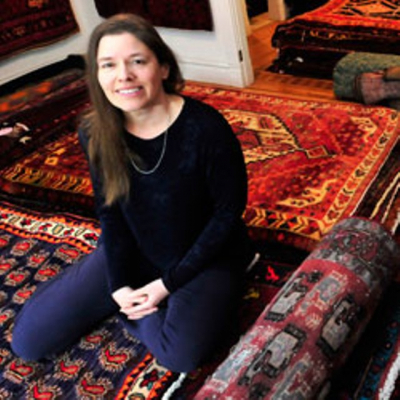Image of Kirsten Edey sitting on patterned carpets
